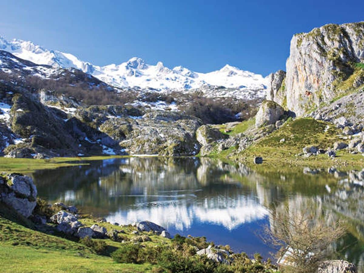 Paisaje rural genérico de Cantabria, casa tradicional en prado verde junto a montaña, como imagen de contexto para la introducción del artículo