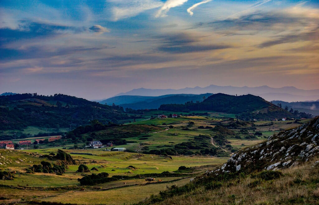 Fachada del albergue de peregrinos La Cabaña del Abuelo Peuto en Güemes, con caminantes del Camino de Santiago