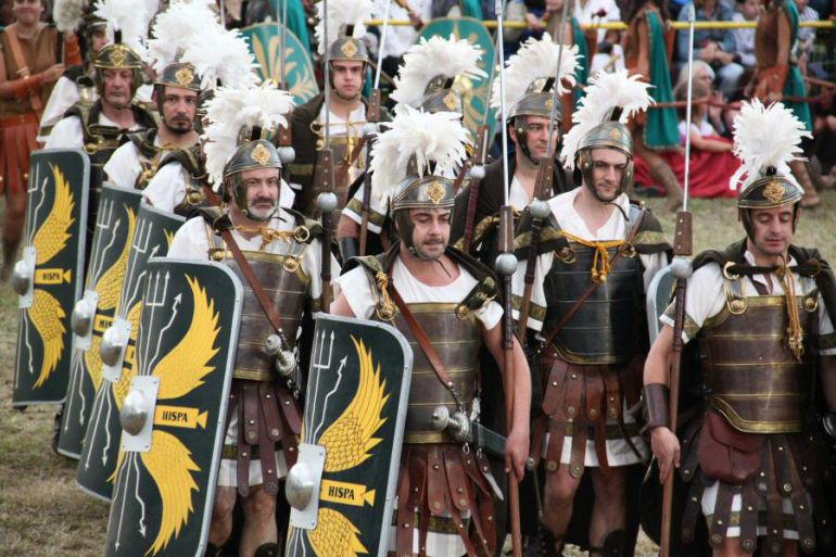 Desfile de legionarios romanos y guerreros cántabros por la calle principal de Los Corrales de Buelna