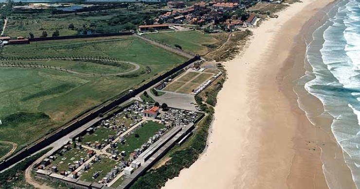 Playa de Berria en Santoña, tramo largo de arena con el kiosco de alquiler de hamacas